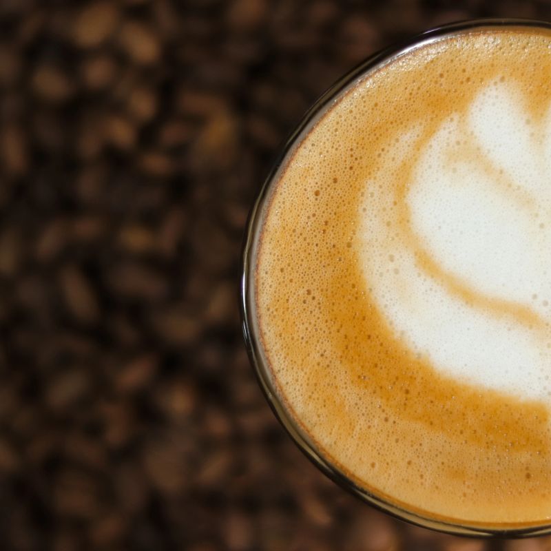 Barista crafting fresh specialty coffee at Ela Coffee counter